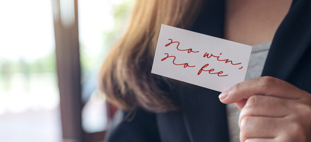 woman holding card that reads "no win, no fee"